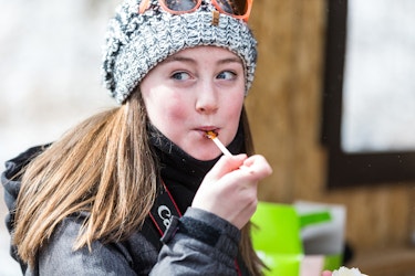 Girl Eating Maple Syrup Sucker
